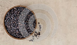 Himalayan crystal black salt in a wooden bowl on a beige background. Spices background. Flatley. Copy space.