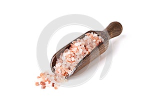 Himalayan crystal tibetan pink coarse sea salt in wooden scoop isolated