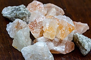 Himalayan lamp white and pink salt crystals for therapy on wooden background.
