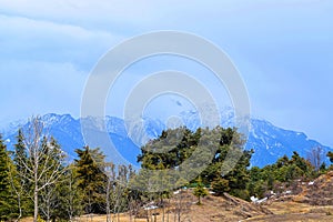 Himalayan Landscape - Blue Mountains with Snowy Summits, Green Trees, and Blue Cloudy Sky - Deoriya Tal, Uttarakhand, India