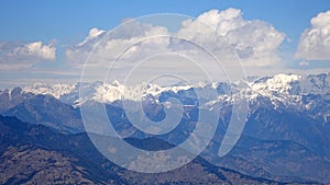 Himalayan mountain range with snow on peaks and cloudy sky