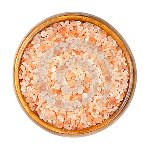 Himalayan salt, coarse crystals, table salt in a wooden bowl