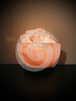 Himalayan salt lamp in the dark. Vertical phot image.