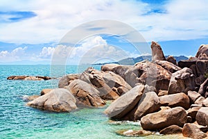 Hin Ta and Hin Yai rocks close up, Grandmother and Grandfather stones on blue sea and sunny cloudy sky background, Samui, Thailand