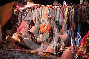 Hindu bells at door of temple tinted in orange tika.