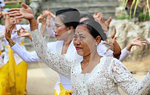 Hindu celebration at Bali Indonesia, religious ceremony with yellow and white colors, woman dancing.