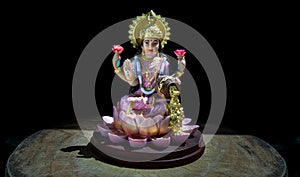 Hindu cosmos Maha laxshmi statue decorated with Flower Garland. Statue of Goddess of Wealth