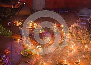 Hindu devotee praying and lighting incense stick in a temple