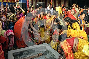 The Hindu devotees are busy in a holy ritual in front of a Homa Kund.