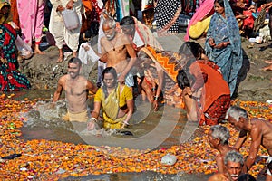 Hindu devotees come to confluence of the Ganges River for holy dip during the festival Kumbh Mela