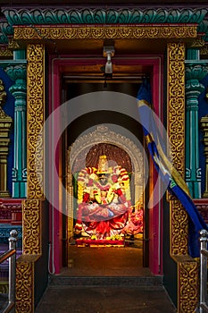 Hindu divinity sculpture insidel of temple in Batu Caves campus