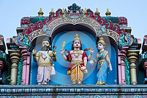 Hindu divinity sculptures on the roof of temple in Batu Caves campus