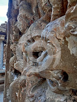 Hindu God deity statue. Ancient sandstone carved historical Hindu God sculptures in the temple walls.