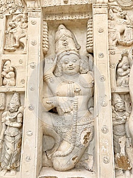 Hindu God deity statue. Ancient sandstone carved historical Hindu God sculptures in the temple walls.