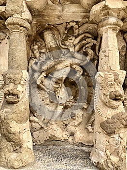 Hindu God deity statue. Ancient sandstone carved historical Hindu God sculptures in the temple walls.