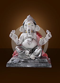 Hindu God Ganesha on brown background, Ganesha Idol. Ganesh festival