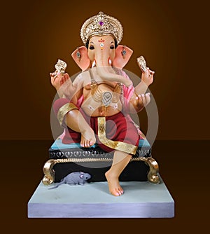 Hindu God Ganesha on brown background, Ganesha Idol. Ganesh festival