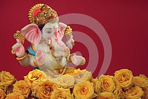 Hindu God Ganesha with rose flower