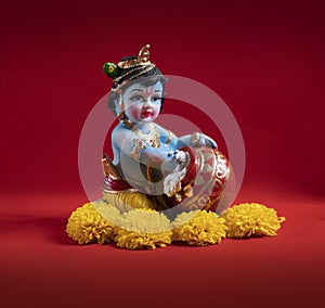 Hindu God Krishna on red background indian dahi handi festival