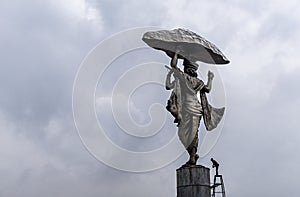 hindu god lord krishna isolated statue from behind with bright background at morning