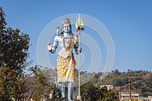 Hindu god shiva statue with bright blue sky background at morning from different angle