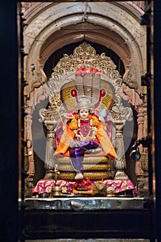 Hindu God Vishnu siting on a snake (Shesha)at Shri Ram Temple complex at Phaltan photo