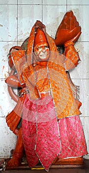 Hindu God & x27;Hanuman& x27; idol in a temple with traditional cloths and vermilion or & x27;sindoor photo