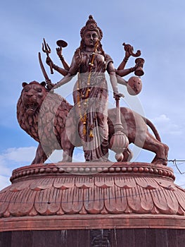 Hindu Goddess Durga maa statue with lion and her ayudhas photo