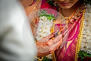 Closeup of Mangal Sutra or Thaali of an Indian Hindu Bride wearing garland and golden jewelry photo