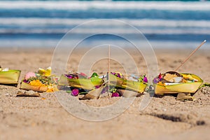 Hindu offerings and gifts to god on the beach in Bali, Indonesia