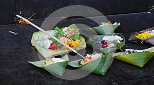 Hindu offerings in palm leaf bowls Seminyak Beach Bali