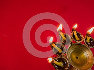 Hindu puja essential panch pradeep or five headed oil lamp burning with glowing flame. these are used in durga , saraswati , kali