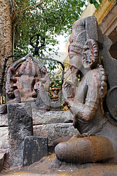 Hindu temple statue in sitting worship pose with devotion