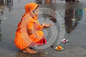 A Hindu woman praying at the Ganges .