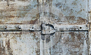 Hinge on a rusty metal door. vintage iron background