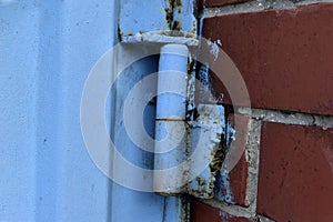 Hinged iron hinges on garage doors in blue photo