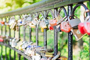 Hinged love locks hanging on a bridge