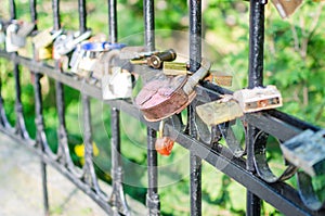 Hinged love locks hanging on a bridge