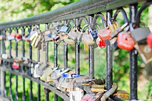 Hinged love locks hanging on a bridge