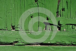 Hinges on old barn wooden door with a shabby green paint, grunge horizontal background