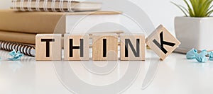 Hink small or think big. Hand flips a cube and changes the words `think small` to `think big` or vice versa. Beautiful white