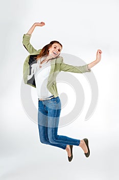 Hip hip hooray Its another beautiful day. Studio portrait of a happy young woman jumping for joy against a grey
