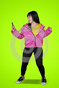 Hip-hop dancer dancing with phone on studio