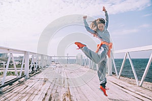 Hip hop dancer in fashion sportswear jumping and dancing in the street