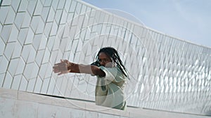 Hip-hop man dancing street closeup. Trendy dancer rehearsing choreography alone