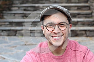 Hip man smiling wearing eyeglasses and hat