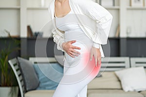 Hip pain, woman suffering from osteoarthritis at home