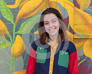 Hip sixteen year old girl in front of a garage door mural in South Philadelphia