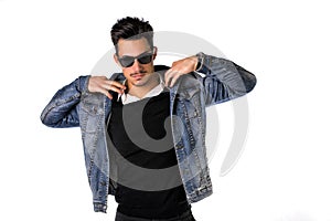 Hip, trendy young man with sunglasses and denim jacket