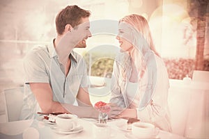 Hip young couple having desert and coffee together